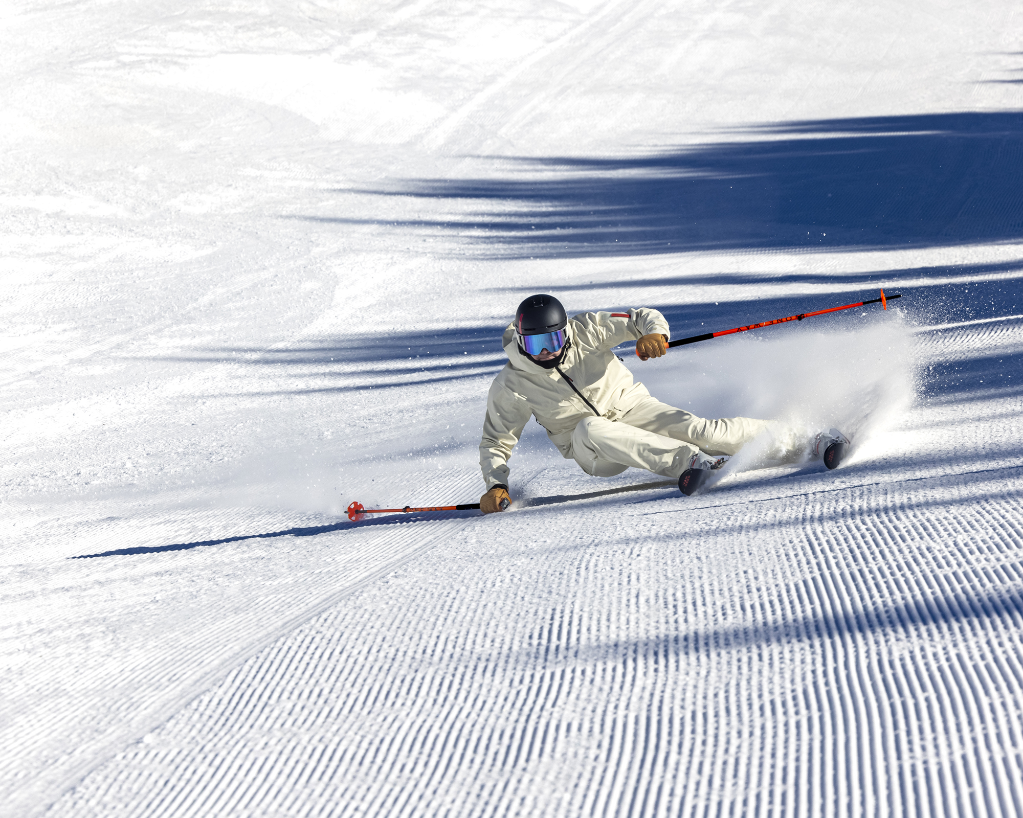 A skier carving turns above Zermatt with the Matterhorn in view